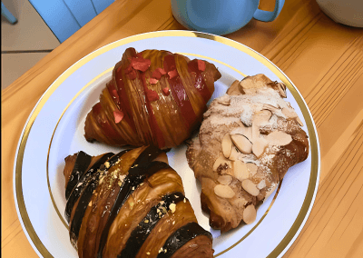 Freshly baked almond and chocolate croissants served on a plate at GG’s Pastry Shop in Mount Airy, MD