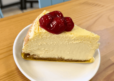 Slice of cheesecake topped with strawberry sauce at GG’s Pastry Shop in Mount Airy, MD