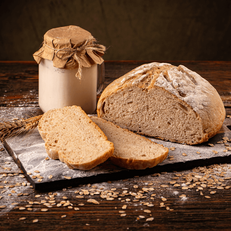 Loaf of artisanal bread sliced on a wooden board at GG’s Pastry Shop in Mount Airy, MD